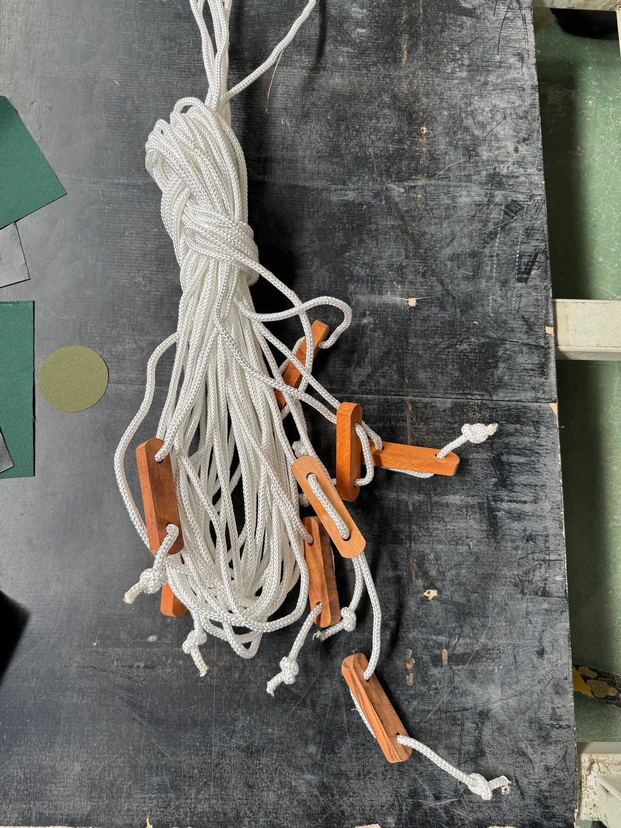 Tent guy lines with wooden tension adjusters prepared in the workshop