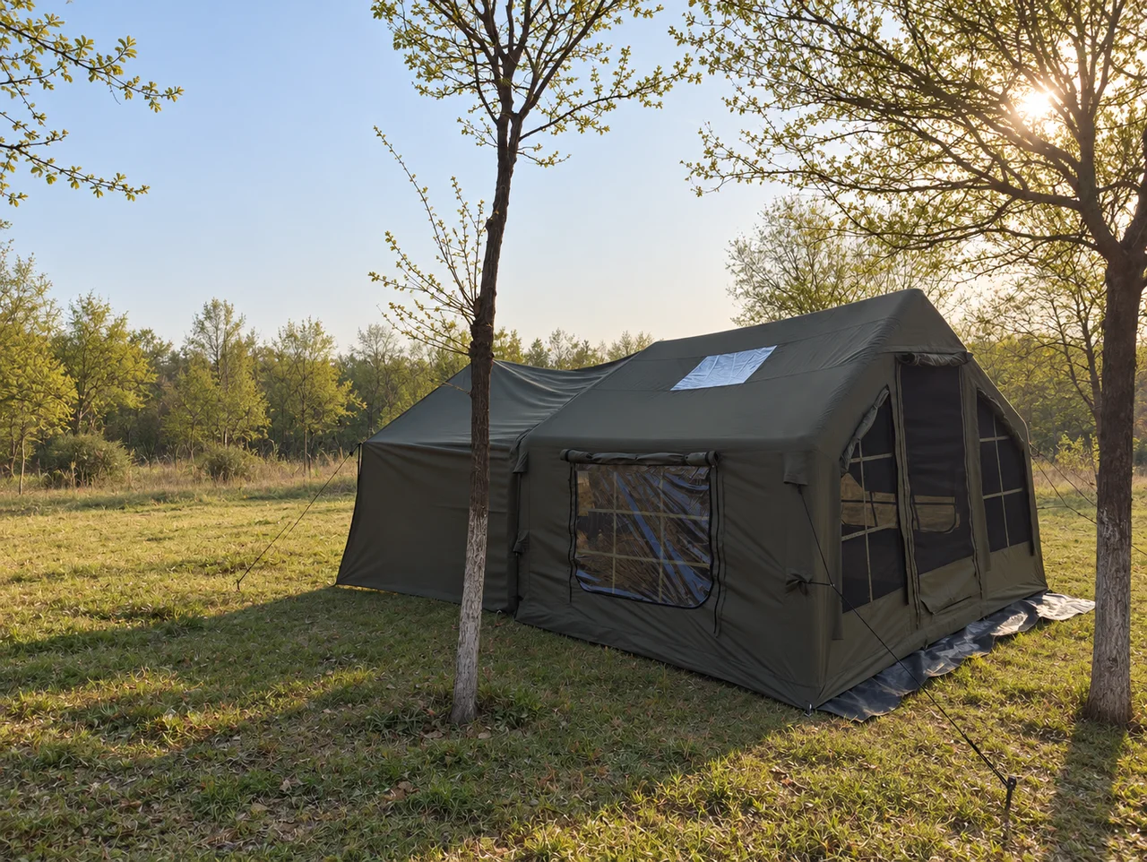 Dark olive nine square metre inflatable camping tent set up outdoors