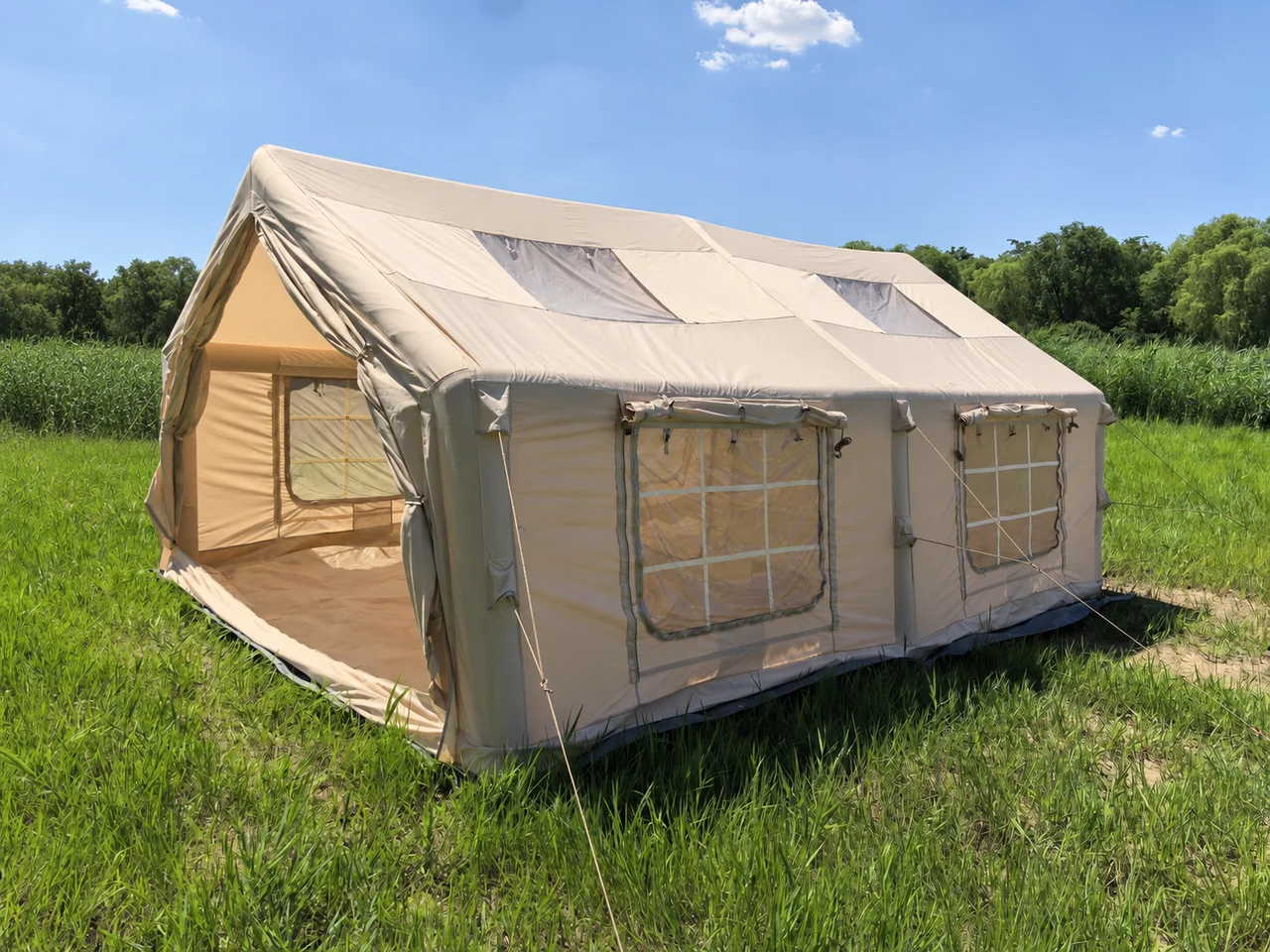 LT-18.16 inflatable camping tent with an open entrance and side windows in a grassy outdoor setting