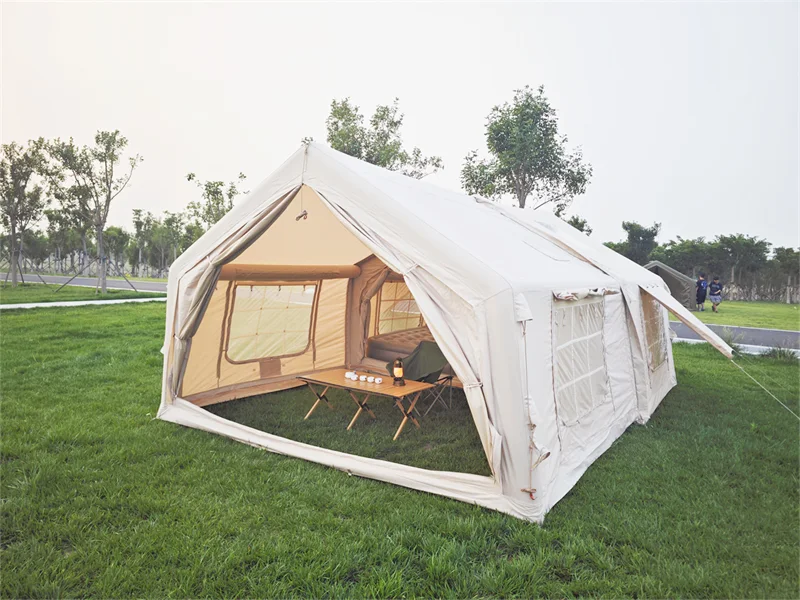 Open front of the modular inflatable tent showing furniture scale and circulation